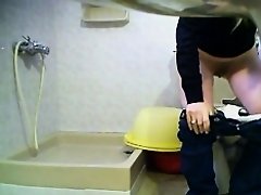 Blonde girl in jeans is peeing on the hidden cam in toilet